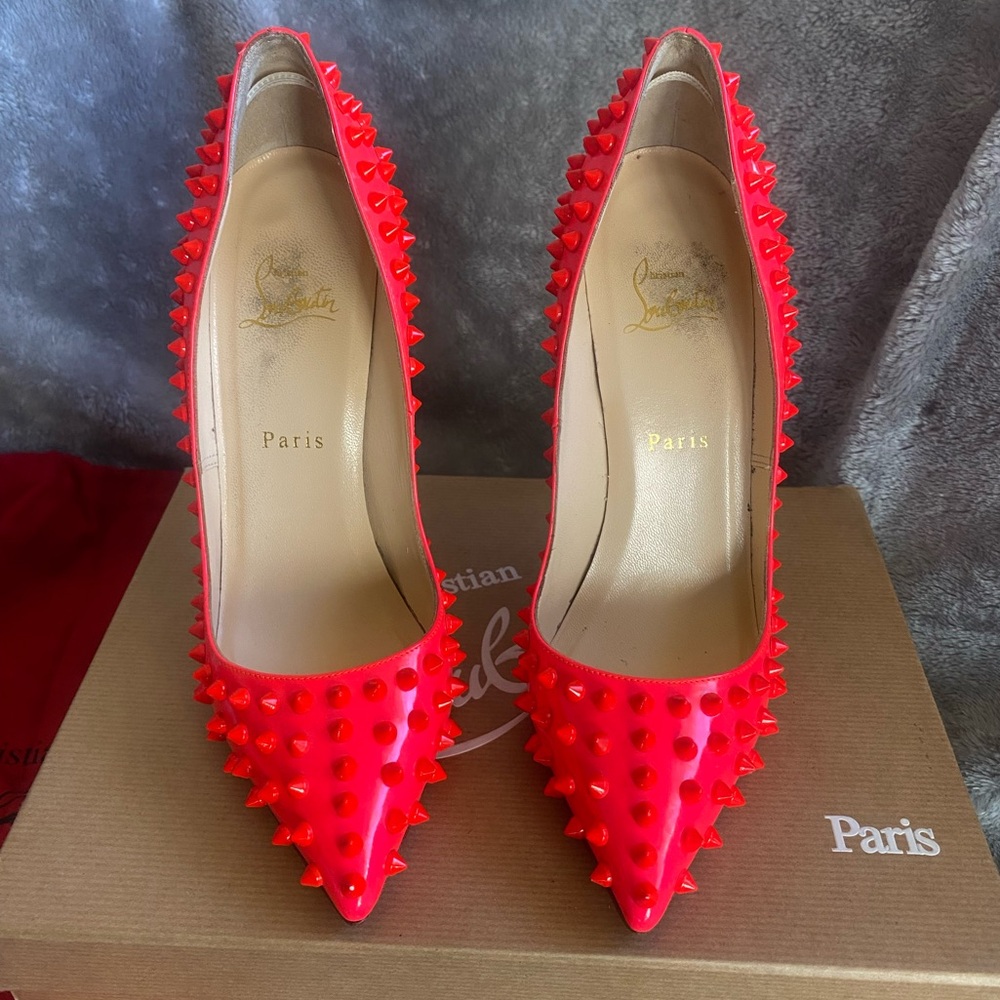 Bright fluorescent pink spiked Christian Louboutin heels